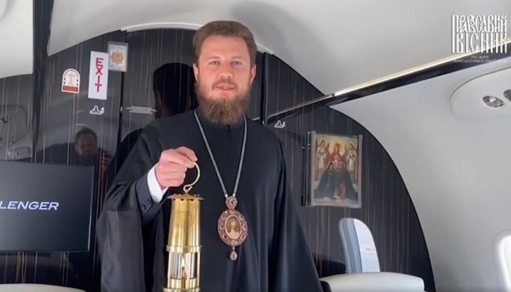 Bishop Victor (Kotsaba) aboard the plane with Holy Fire. Photo: a video screenshot from the “Pravoslavny Visnyk” FB page